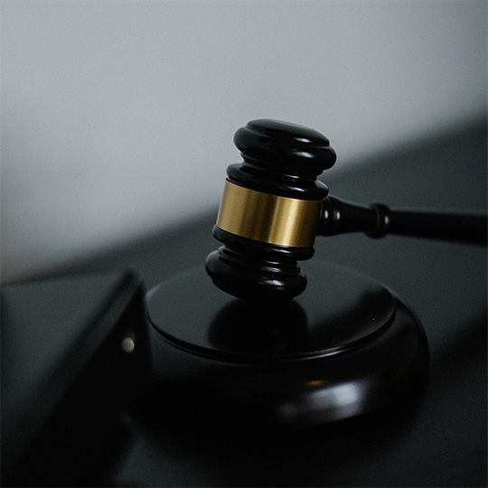 A close-up of a judge's gavel placed on a desk, representing the legal system and decision-making.